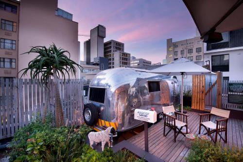 een zilveren luchtstroomtrailer met een tafel en stoelen bij Grand Daddy Boutique Hotel in Kaapstad