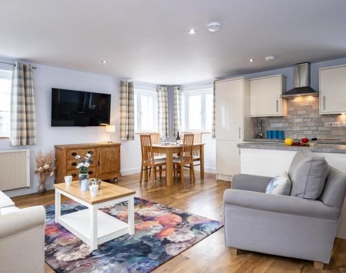 a living room with a couch and a table at The Hideaway in Port Isaac
