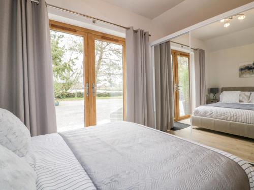 a bedroom with two beds and a large window at Westfields in Launceston