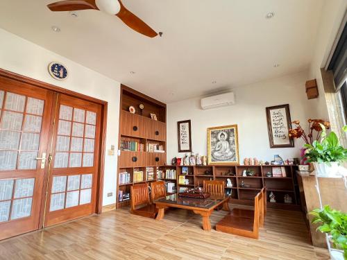 a living room with a table and chairs and bookshelves at Samatha Hotel Bai Chay, Ha Long in Ha Long