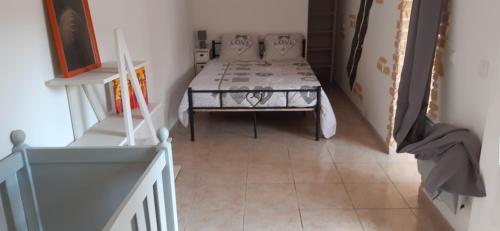 a small bedroom with a bed and a staircase at Le Casot in Torreilles