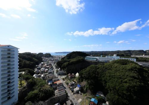 a view of a city with trees and buildings at Katsuura Hilltop Hotel & Residence in Katsuura