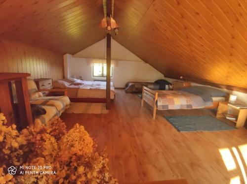 a large room with two beds and a ceiling at Stodola in Cetenov