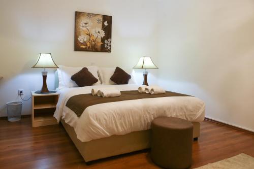 a bedroom with a large bed with two lamps at Holiday house "Mimoza" 2 massage pools in Otočac