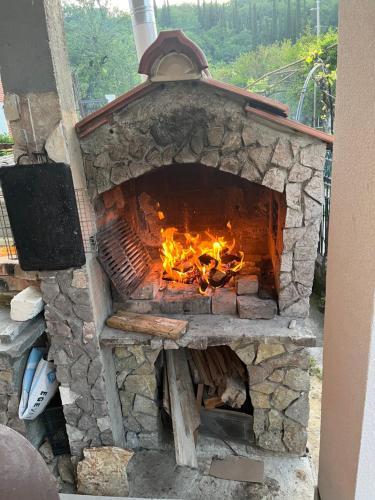 a stone fireplace with a fire in it at Apartment’s Maric - Zelenika,Herceg Novi in Zelenika