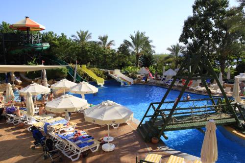 a large swimming pool with umbrellas and a slide at AQI Pegasos Royal in Avsallar