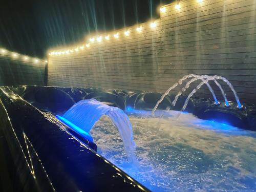 a jacuzzi tub with two water jets at Stunning Pet-Friendly Home with Hot Tub less than one minute walk from Barmouth Beach in Barmouth