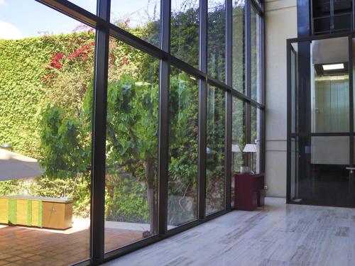 an empty room with glass doors and a plant at Ciutat de Granollers in Granollers