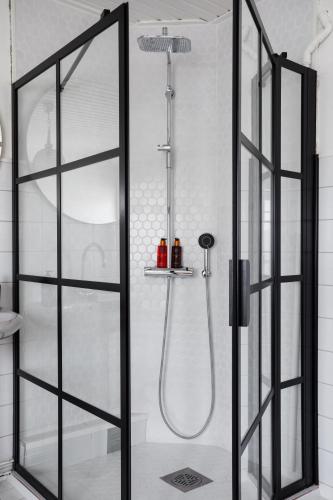 a shower with a glass door in a bathroom at Bridget Inn in Naantali