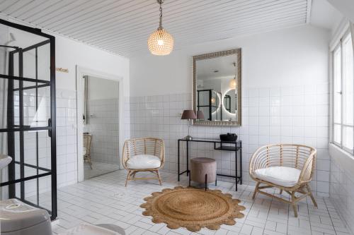 a bathroom with two chairs and a mirror at Bridget Inn in Naantali