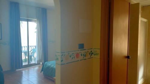 a room with a room with a bed and a window at Hotel San Pietro in Letojanni