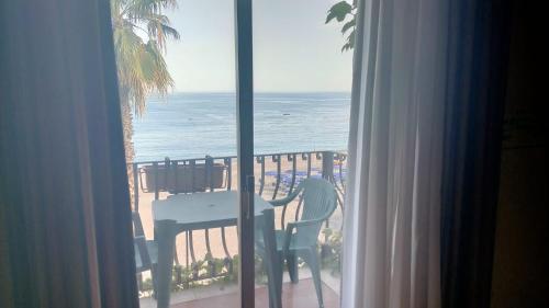 a room with a view of the ocean from a window at Hotel San Pietro in Letojanni
