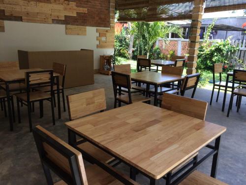 a dining room with wooden tables and chairs at Làng biển Homestay in Quang Ngai