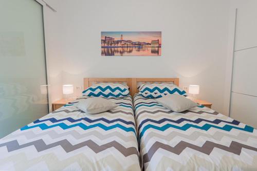 a bedroom with a bed with two pillows on it at Apartman Marica in Split