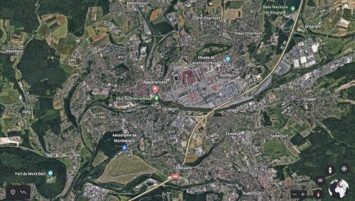 a map of a city with red and blue at Appartement avec place de parking et box vélos in Montbéliard