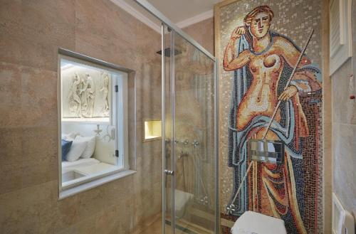 a bathroom with a mosaic of a woman in a shower at Vinifera Ephesus Hotel in Selçuk