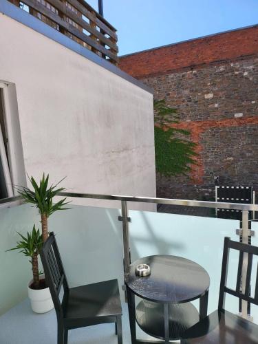 a balcony with two chairs and a table and a wall at Gemütliche Dachwohnung mit kleiner oder großer Dachterrasse nebeneinander in Wolmirstedt