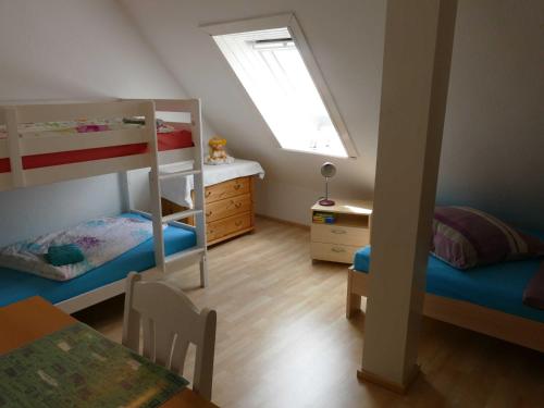 a small room with two bunk beds and a table at Ferienwohnung "Zur Schmiede" Objekt-ID 11824 in Torgelow am See