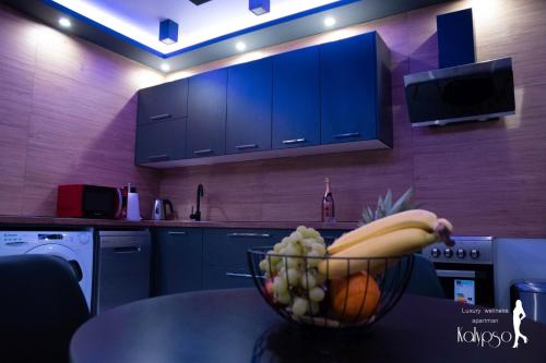 a bowl of fruit on a table in a kitchen at Wellness Apartment Kalypso in Osijek