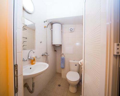 a small bathroom with a toilet and a sink at ALEKS Top Center in Burgas
