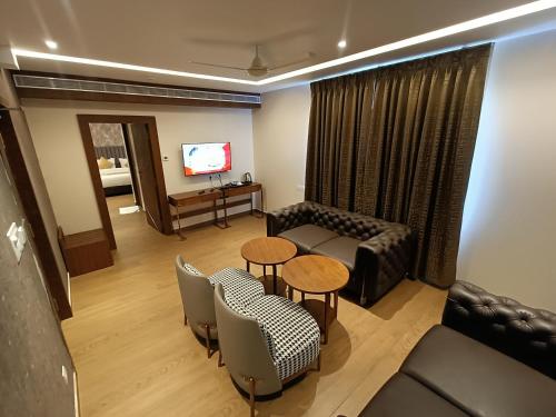 a living room with a couch and a table at The Kings Park Grand-Near US Consulate in Chennai