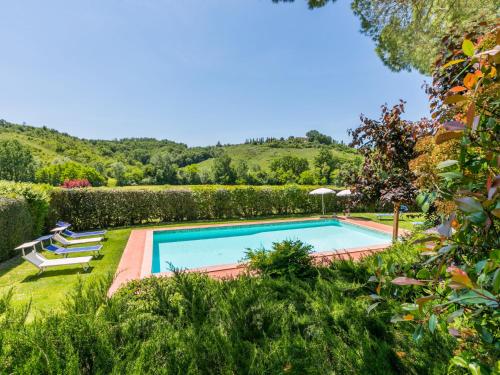 an image of a swimming pool in a garden at Apartment Casolare Bretulla-4 by Interhome in Montespertoli