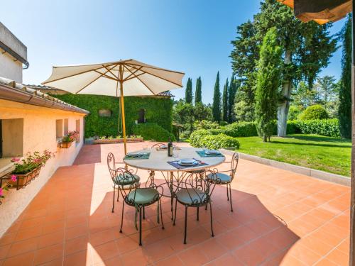 a patio with a table and chairs and an umbrella at Apartment Bardeggiano - Caterina 2 - COL245 by Interhome in Belvedere