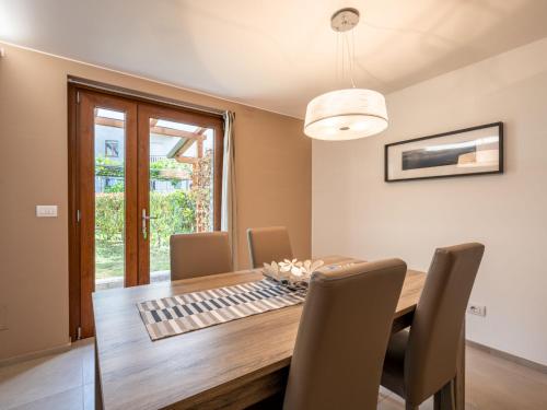 a dining room with a wooden table and chairs at Apartment La Maison d'Amelie by Interhome in Fenis
