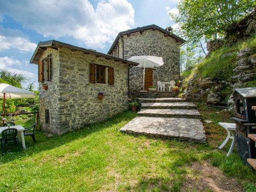 a stone house with a stone path leading to a building at Holiday Home Paradiso II by Interhome in Bolognana