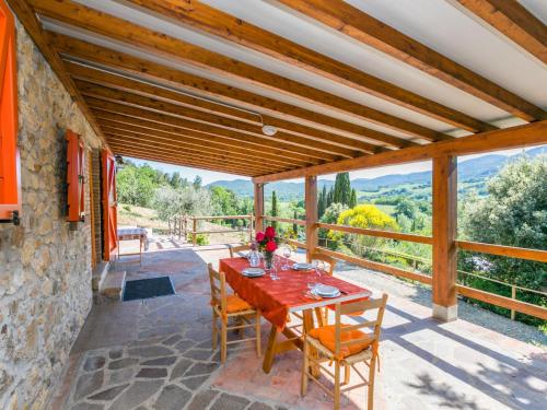 a table and chairs on a patio with a view at Holiday Home Il Felciaio by Interhome in Sassa