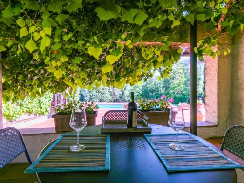 un tavolo con due bicchieri e una bottiglia di vino di Holiday Home Bardeggiano - Caterina 5 by Interhome a Belvedere