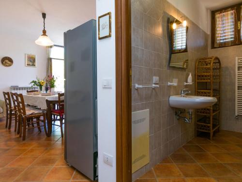 a bathroom with a sink and a dining room at Holiday Home Metallo by Interhome in Colle Val D'Elsa