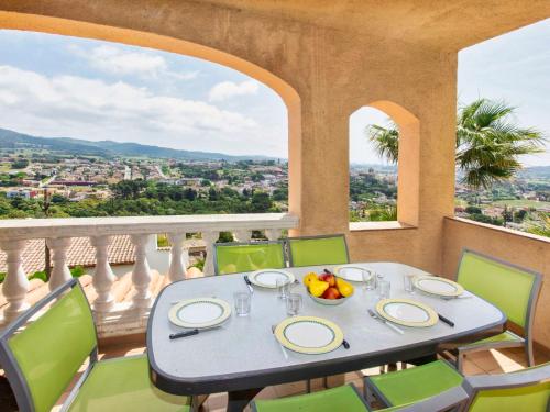 a table with a bowl of fruit on a balcony at Holiday Home Bella Vista by Interhome in Calonge