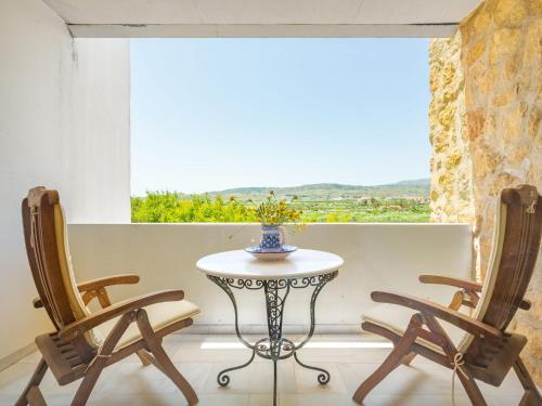 a table and two chairs in front of a window at Holiday Home Finca La Veleta by Interhome in Los Gallardos