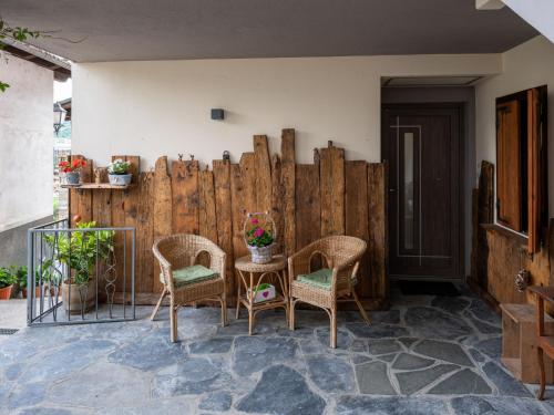 a patio with chairs and a wooden fence at Apartment Cima by Interhome in Aosta