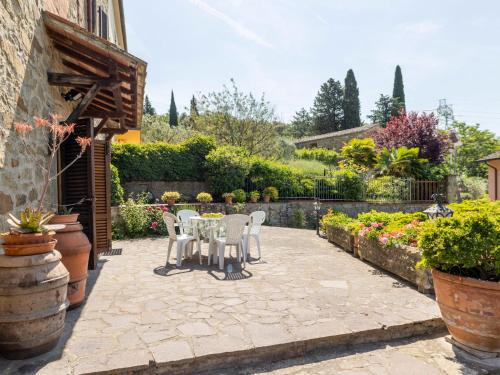 a patio with a table and chairs in a garden at Holiday Home La Casina by Interhome in Pieve a Maiano