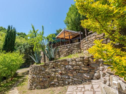 a stone wall with a house on top of it at Holiday Home Vittorio by Interhome in Montorgiali