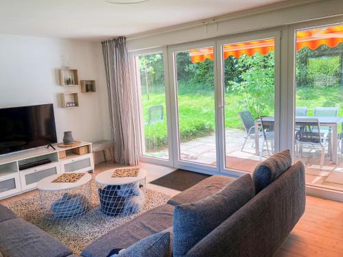 a living room with a couch and a television at Holiday Home Mimi by Interhome in Schönwald
