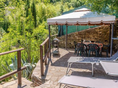 a patio with a table and chairs in a yard at Holiday Home Vittorio by Interhome in Montorgiali