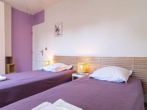 two beds sitting next to each other in a bedroom at Holiday Home Bois d'Astros by Interhome in Rocbaron