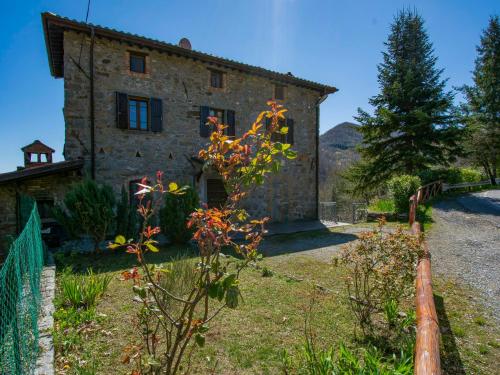 an old stone house with a fence in front of it at Holiday Home Girasole - PZI130 by Interhome in Piazza al Serchio