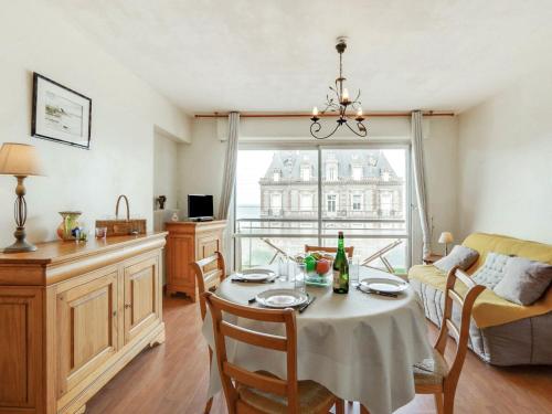 a kitchen and living room with a table and chairs at Apartment Prince Albert by Interhome in Cabourg