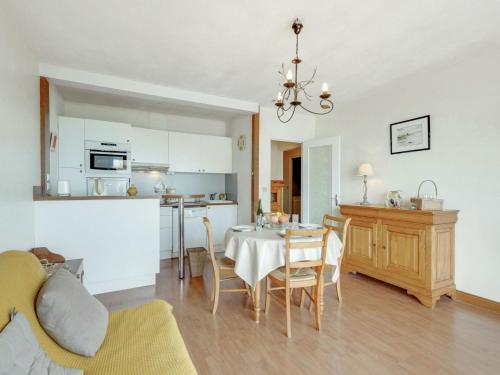 a kitchen and a dining room with a table and chairs at Apartment Prince Albert by Interhome in Cabourg