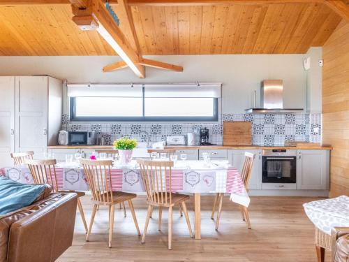 a kitchen with a table and chairs in a room at Holiday Home Les Mouettes by Interhome in Mimizan-Plage