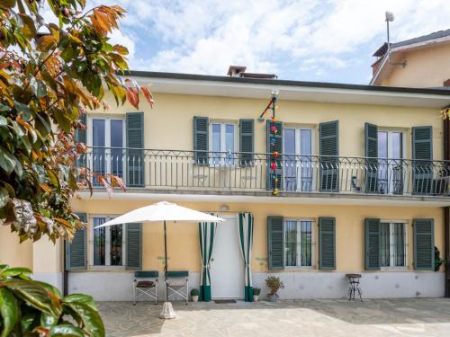 einen Regenschirm vor einem Gebäude mit Balkon in der Unterkunft Holiday Home Casa Margherita by Interhome in Asti