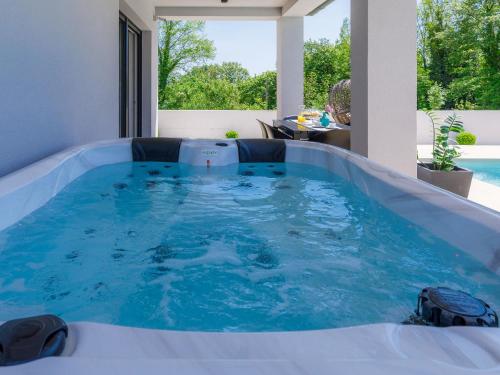 a hot tub in the middle of a house at Villa Vine by Interhome in Marčana