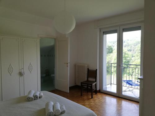 a bedroom with a bed and a sliding glass door at I tulipani in Stresa