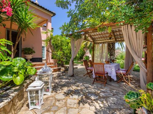 a patio with a table and chairs under a pergola at Holiday Home Isaurinda 1 by Interhome in Faro