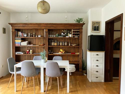 a dining room with a white table and chairs at HoMEMADE Bed and breakfast in Ljubljana