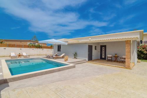 a house with a swimming pool and a patio at Allegra Villa in Kipseli